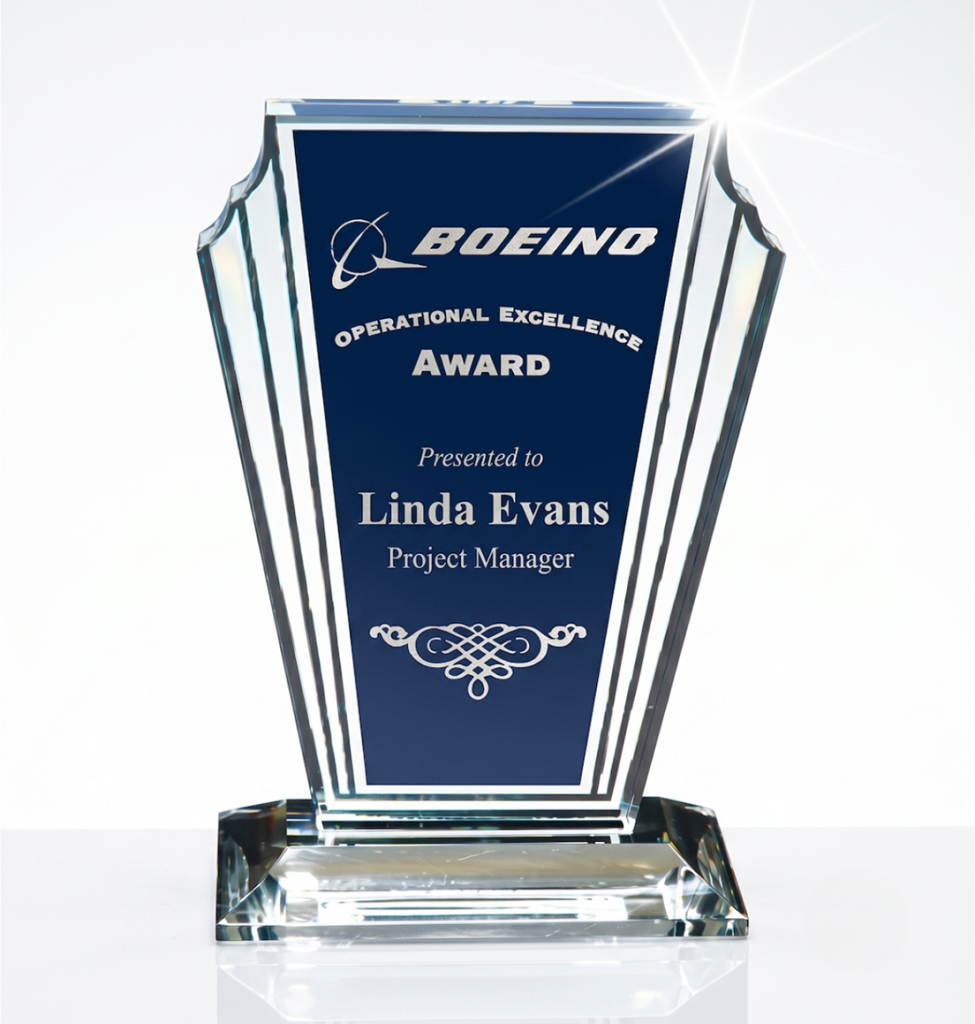 Crystal trophy with a blue panel reading'Boeing Operational Excellence Award' presented to Linda Evans, Project Manager.